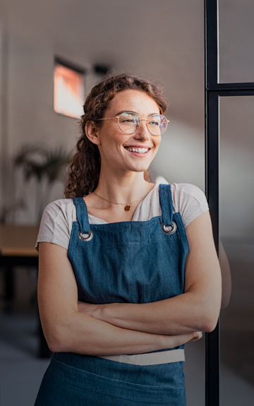 Junge Unternehmerin mit Schürze
