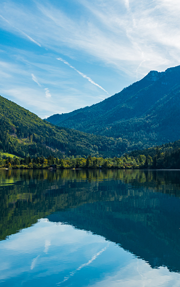 Ein See mit Bergen und Wiesen im Hintergrund